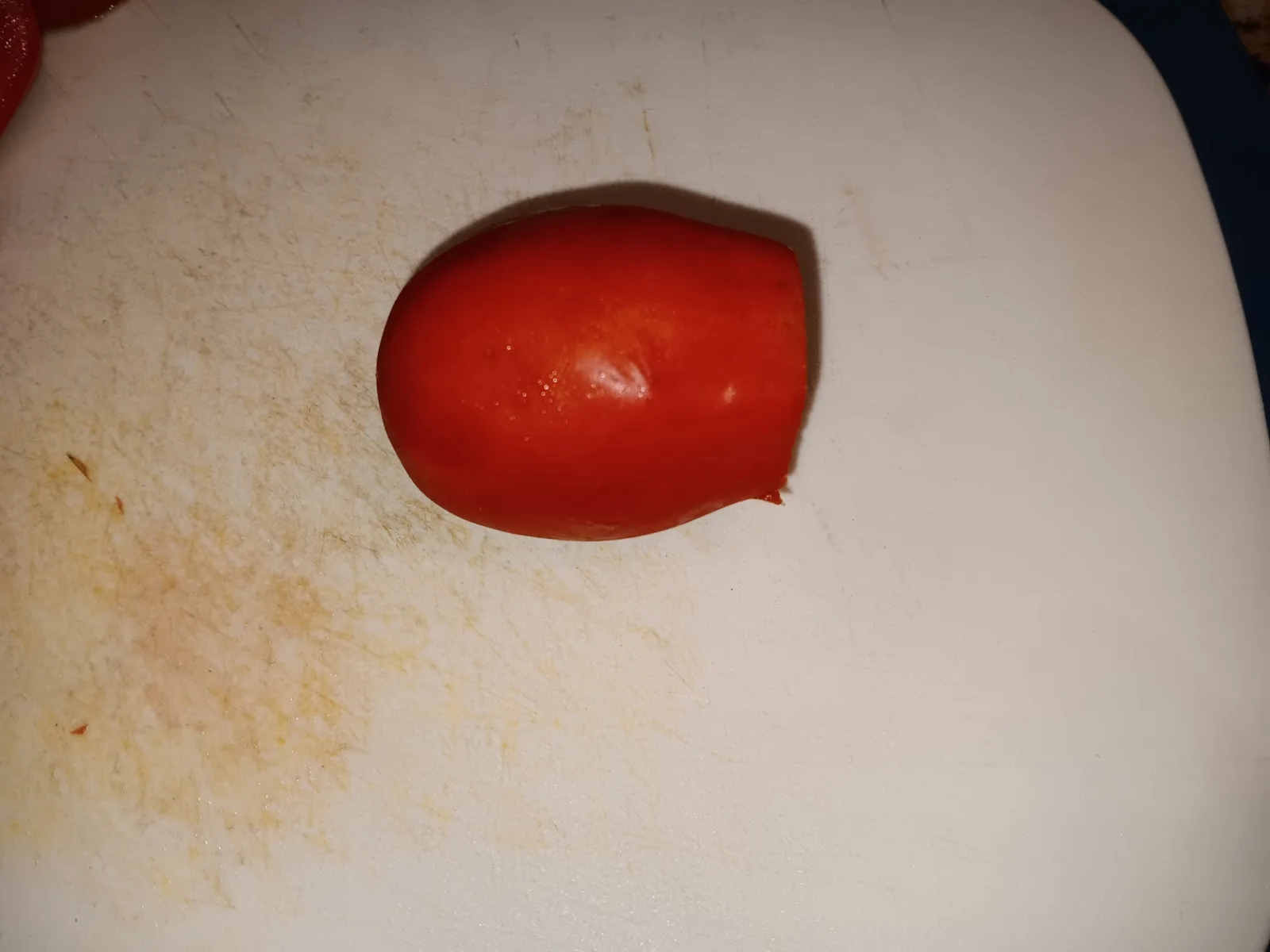 A Roma tomato with its stem end sliced off